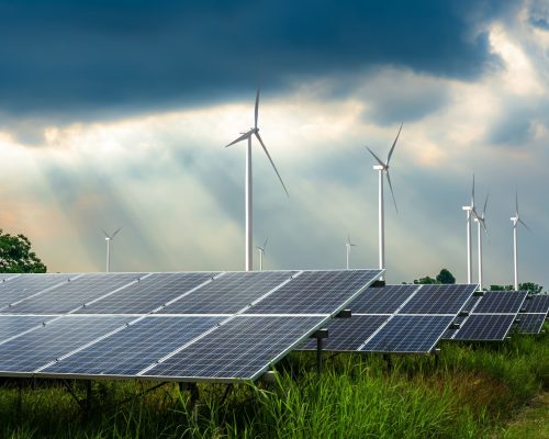 photovoltaic-modules-solar-power-plant-with-wind-turbines-against-with-puffy-fluffy-white-clouds-blue-sky-daylight-background-clean-alternative-power-energy-concept