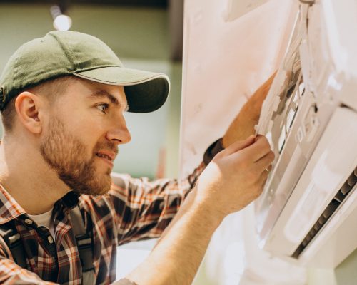 Repairman doing air conditioner servise